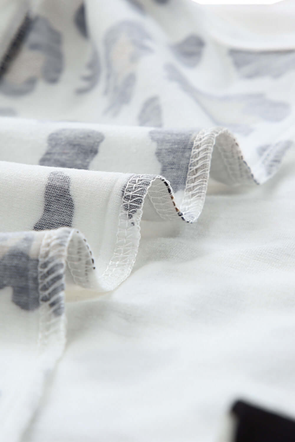 Close-up of crisscross leopard splicing tank top fabric showcasing soft material and stylish leopard print pattern.