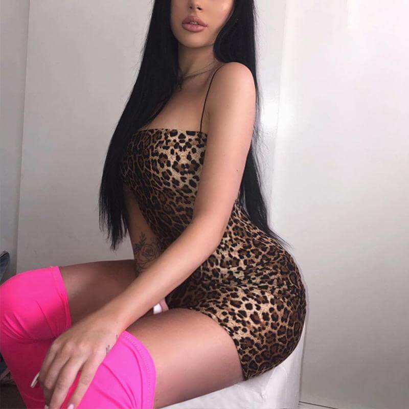 Fierce animal print mini bodycon dress for women, styled with bold pink thigh-high socks.