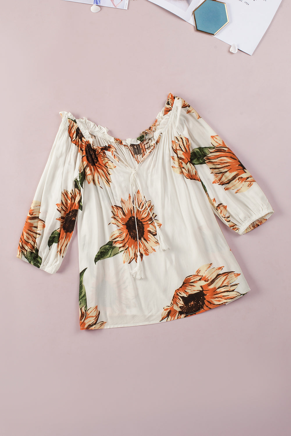 Floral ruffled off shoulder blouse with sunflower pattern and tassel ties, perfect for a feminine summer look.