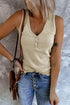 Model wearing khaki ribbed tank top with denim jeans and a stylish bag, showcasing a comfy fall look.