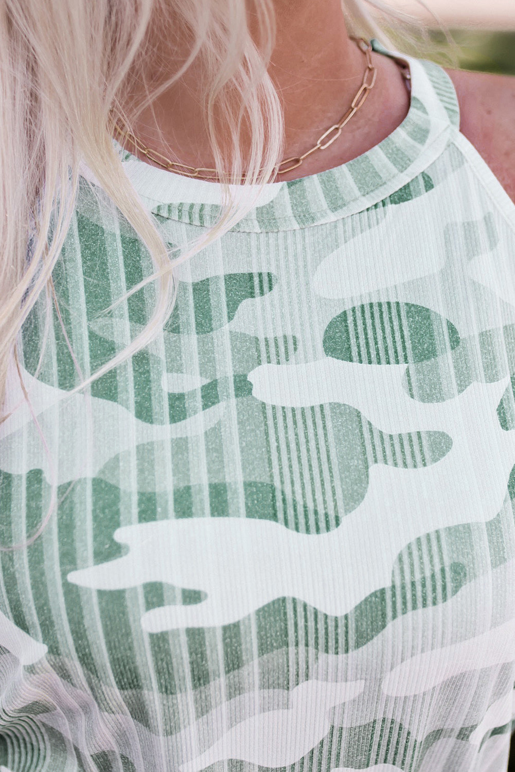 Close-up of green camo tank top showing stylish pattern and texture, perfect for bold and fearless fashion.
