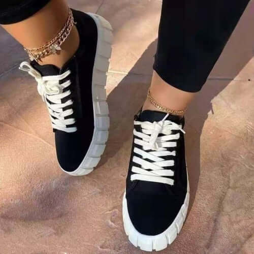 Stylish black and white vulcanized platform sneakers with lace detail, perfect for casual outings and Pinterest-inspired looks.