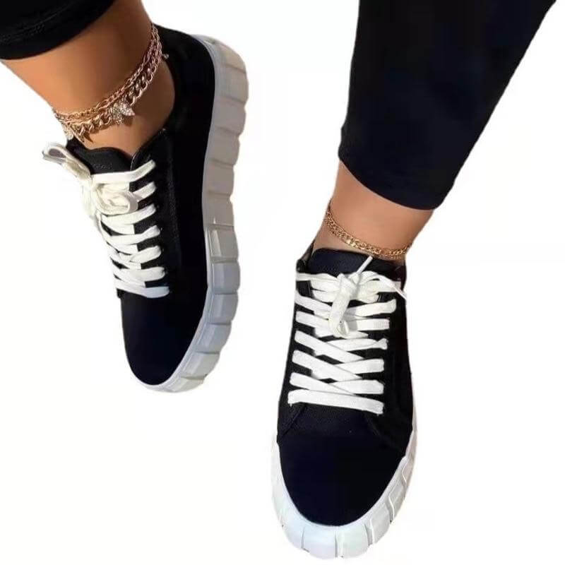 Black and white platform sneakers with lace detailing, perfect for a stylish and breathable look.