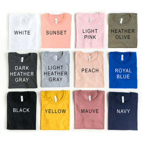 Assorted t-shirts in various colors including white, sunset, light pink, and navy, showcasing a range of styles and sizes.
