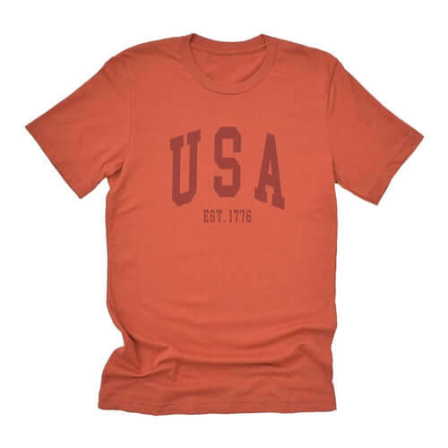 USA Est 1776 short sleeve t-shirt in soft rust color, perfect for casual wear with a relaxed fit.