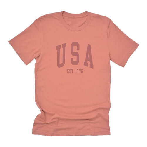 USA Est 1776 short sleeve t-shirt in soft coral, relaxed fit, distressed design, unisex sizing.