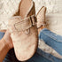 Close-up of vintage-style canvas loafers with a buckle, perfect for retro fashion lovers.