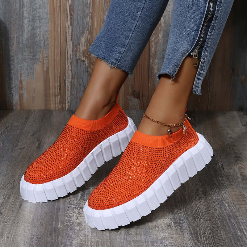 Bold orange mesh platform shoes with white soles, perfect for a stylish and comfortable look.