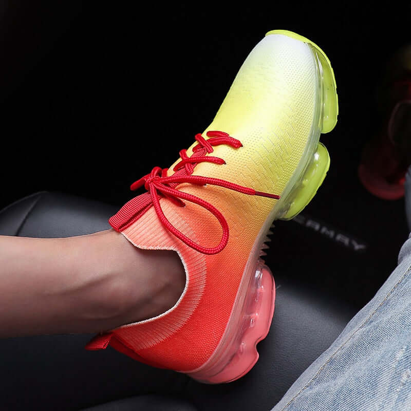 Fashion mesh running shoes for women featuring a vibrant yellow and red gradient with lace-up design.