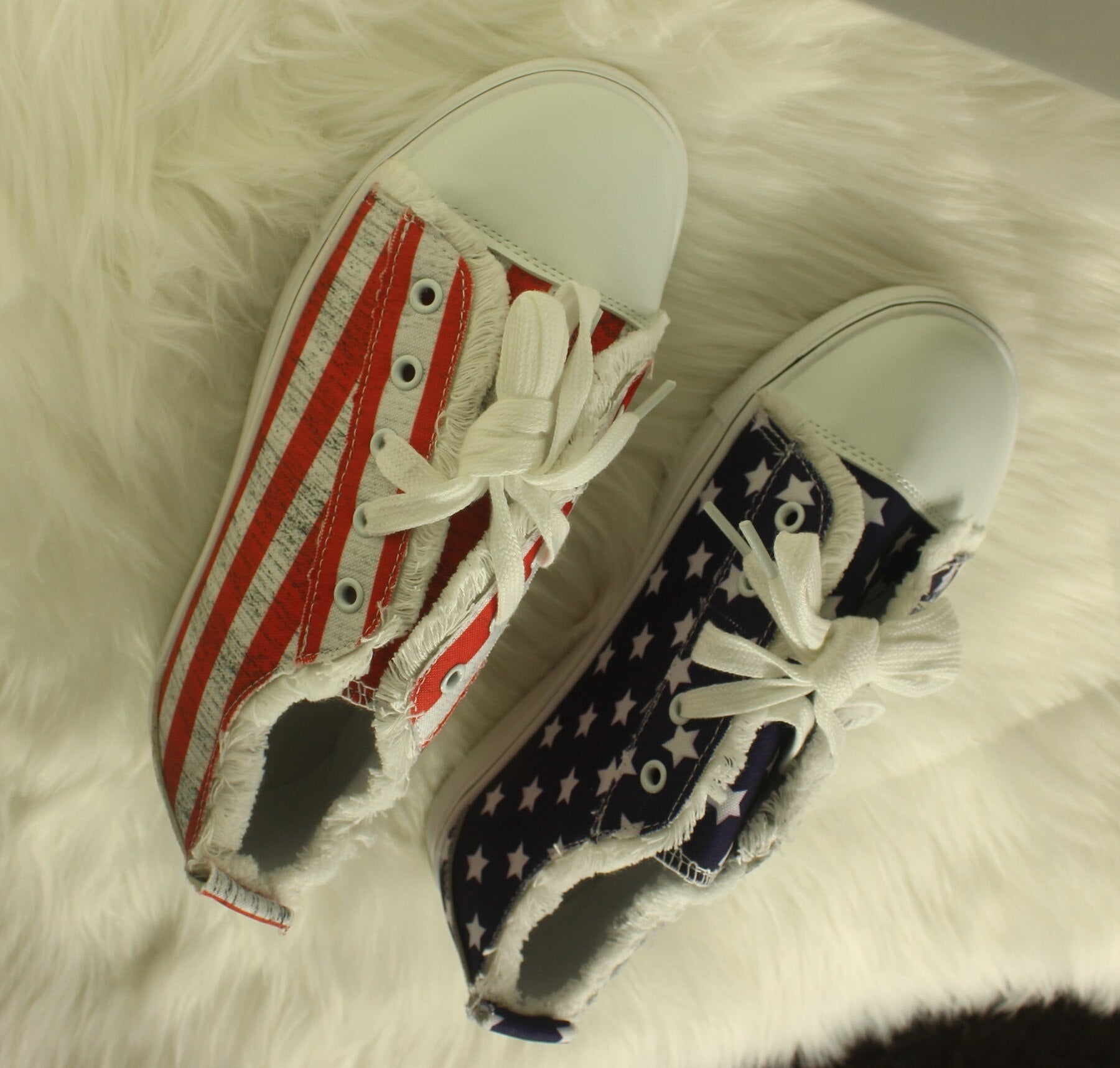 Star striped lace-up sneakers featuring red and white stripes and navy blue with white stars, perfect for casual wear.