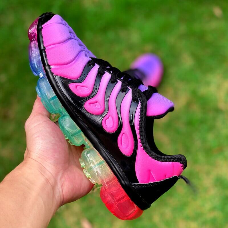 Vibrant pink and black running sneakers with colorful soles, perfect for summer workouts and stylish training sessions.