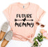 Future Mommy T-shirt in soft peach color with stylish typography, paired with trendy shoes and sunglasses.