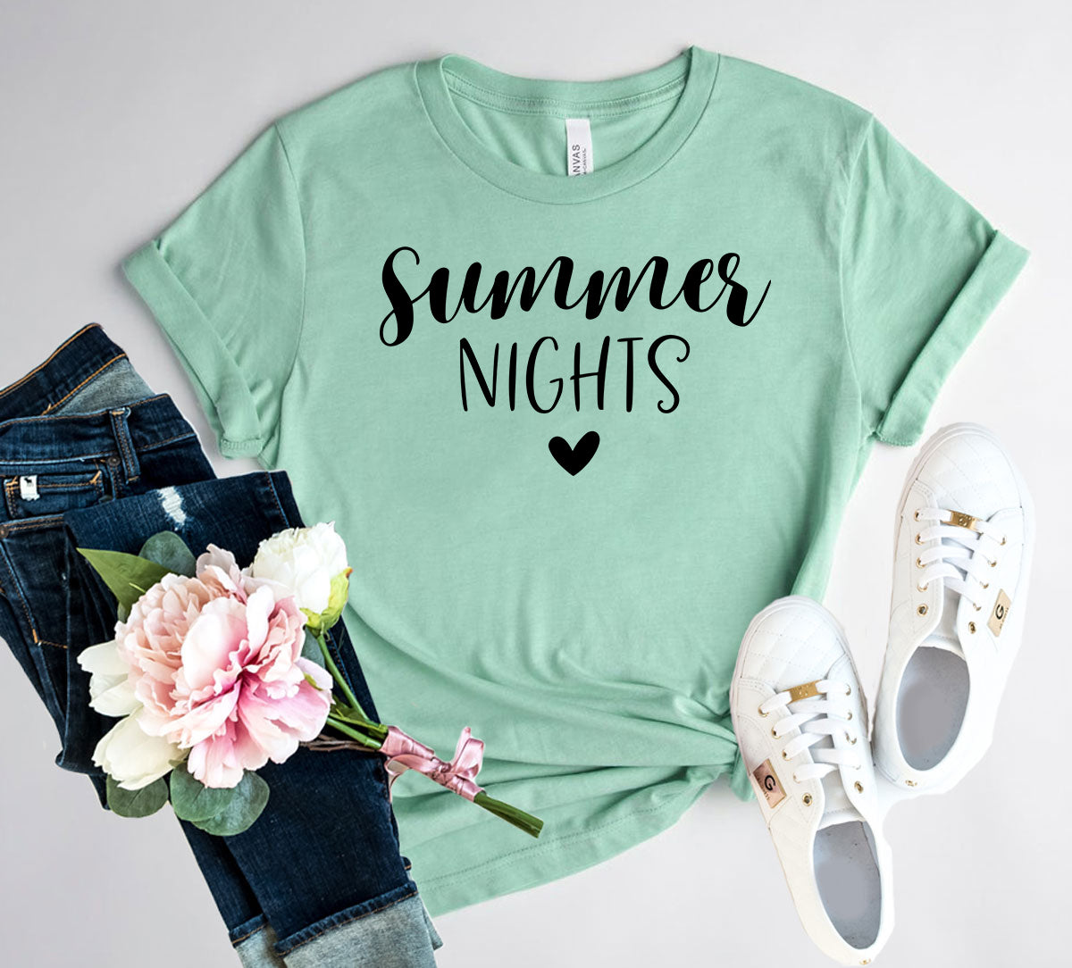 Mint green Summer Nights T-Shirt paired with jeans and white sneakers, perfect for casual outings.