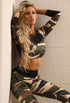 Model in brown and green camouflage leggings and crop top, showcasing stylish activewear design for workouts.