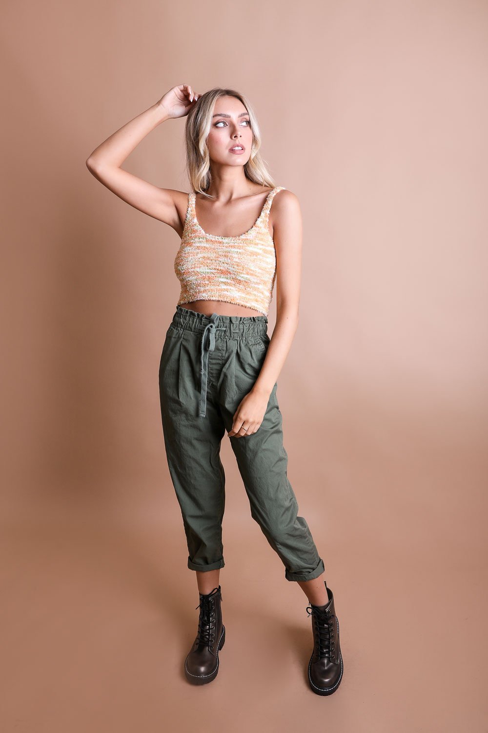Model showcasing the whimsical boucle brami top paired with casual green cargo pants against a neutral background.