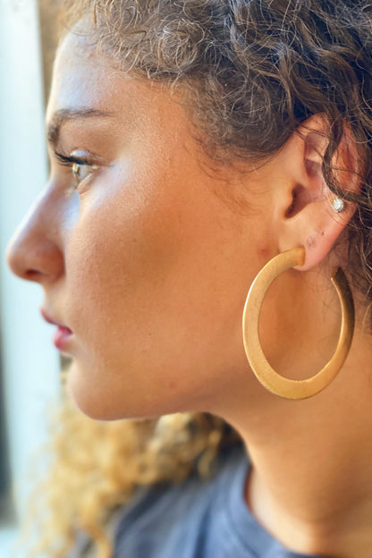 Thick flattened brushed gold hoop earrings, view 4