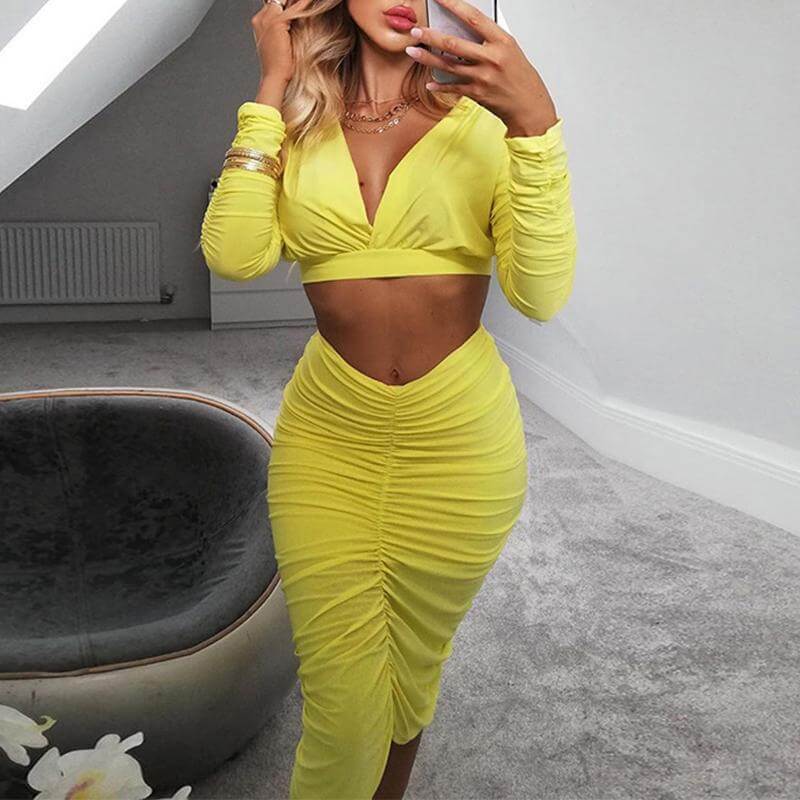 Stylish women in a yellow two-piece pleated long sleeve dress, showcasing elegance and sophistication, perfect for any occasion.
