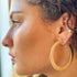 Thick flattened brushed gold hoop earrings