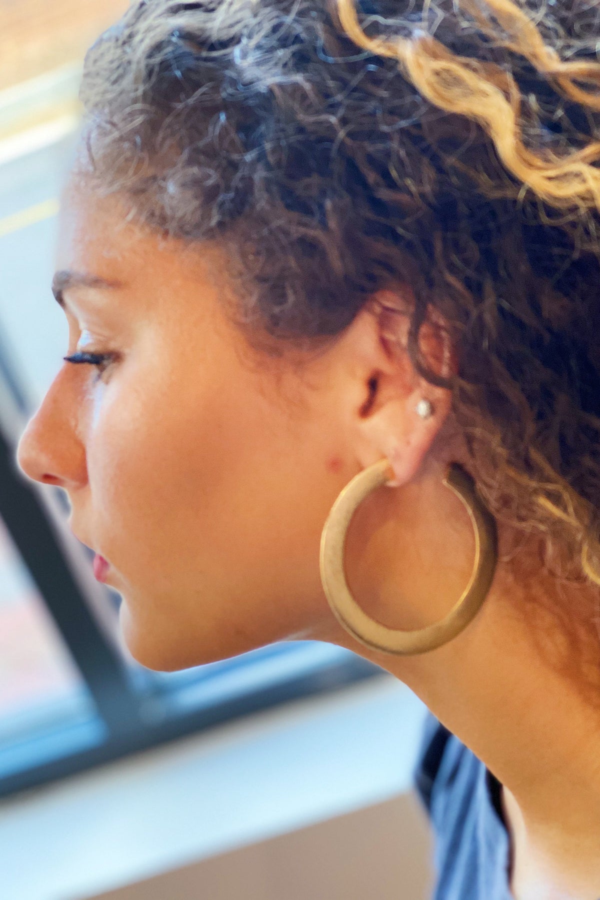 Thick flattened brushed gold hoop earrings, view 3