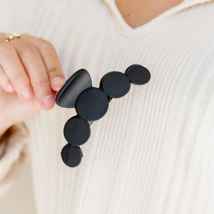 Large 4 inch matte black claw clip with circle design, view 2