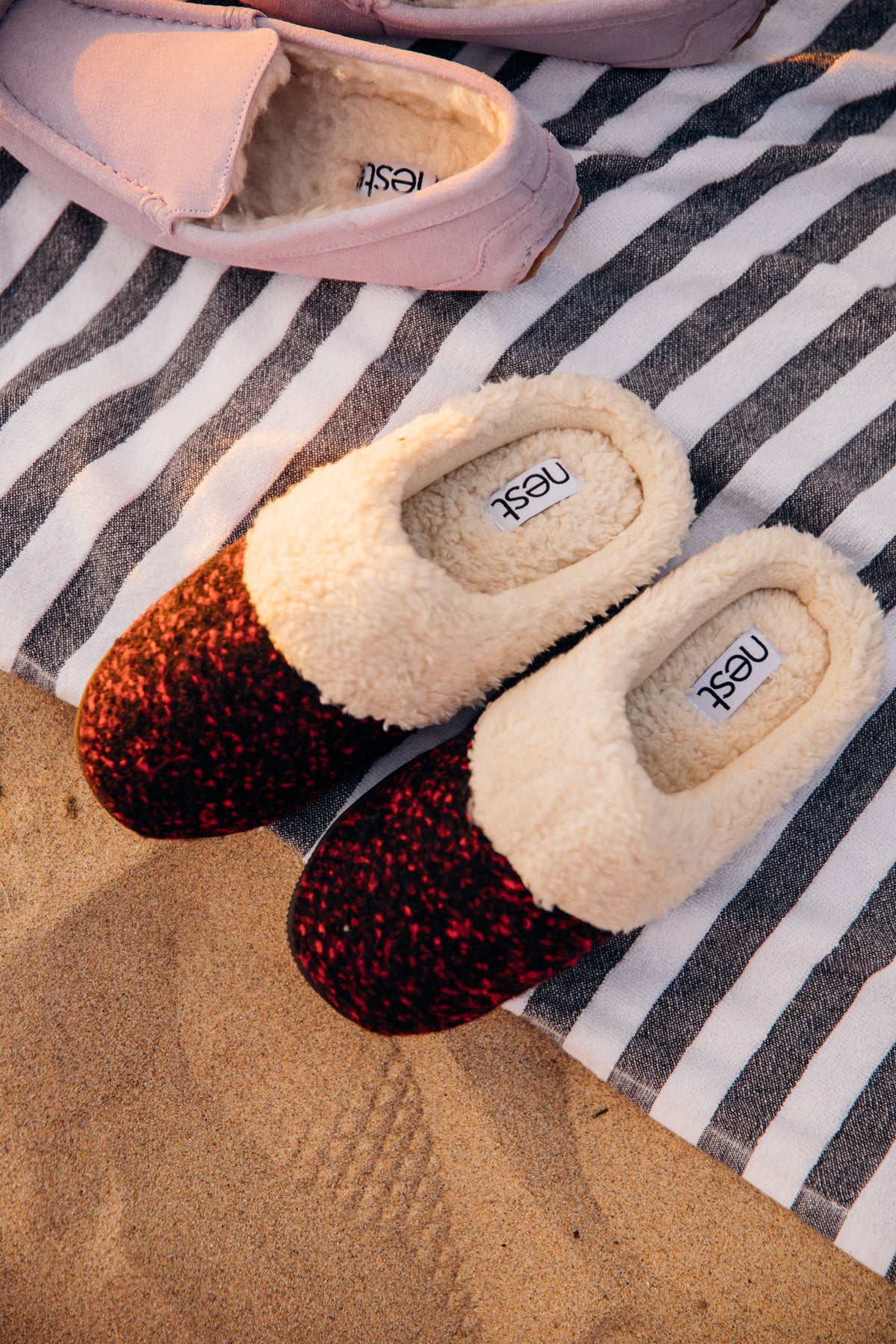 Wine red knit slippers with faux fur cuff, worn view