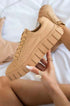 Beige platform lace-up sneakers in a stylish, light design, perfect for a chic casual look.