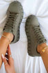 Light breathable green platform sneakers with lace detailing, styled with accessories on a white background.