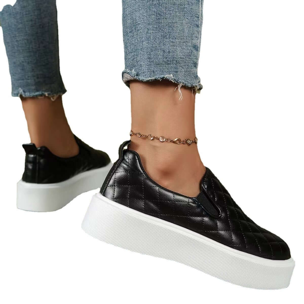 Black slip-on flats loafers with quilted design and white platform, perfect for casual everyday wear.