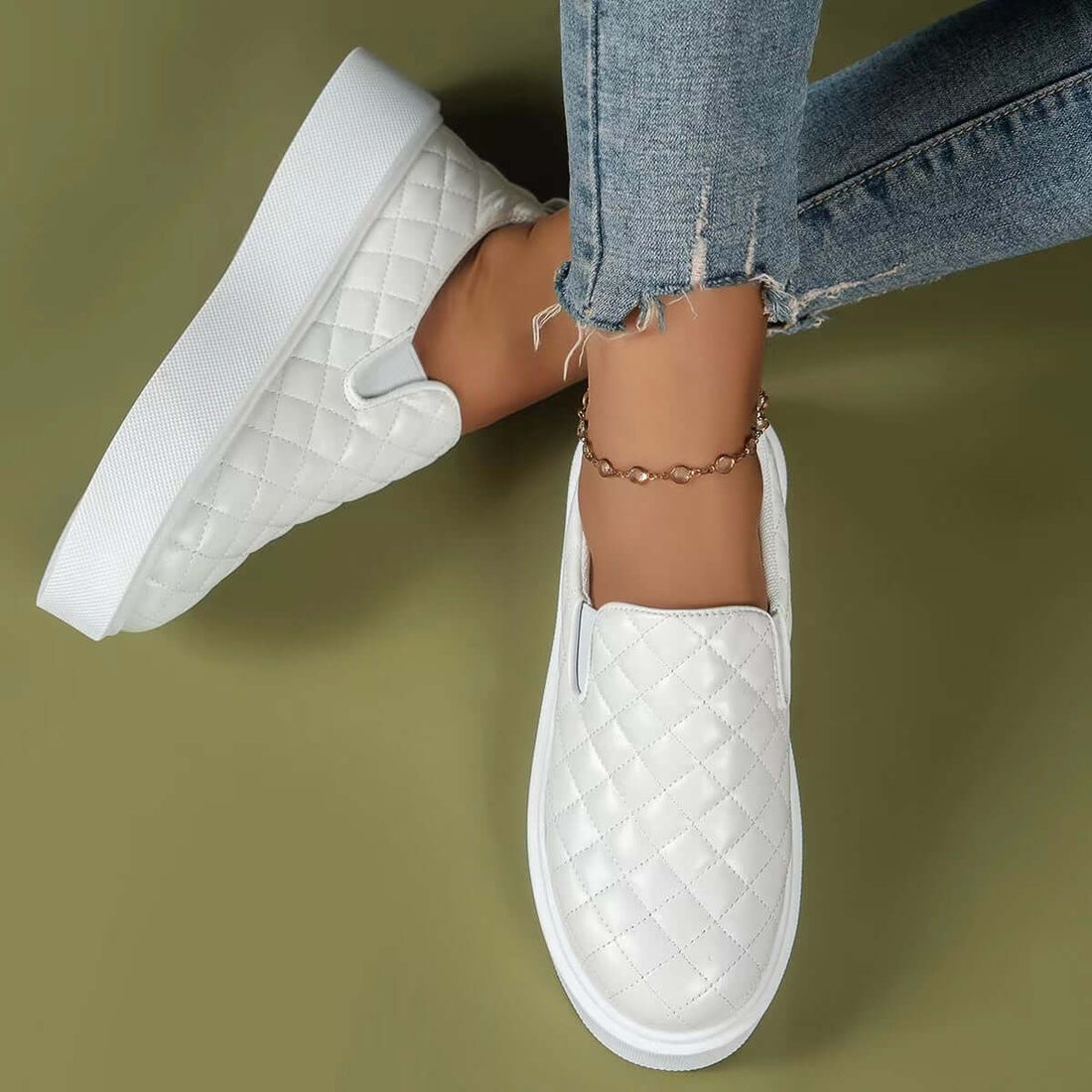 White slip-on flats loafers featuring a quilted design, perfect for casual everyday wear and adding stylish comfort.