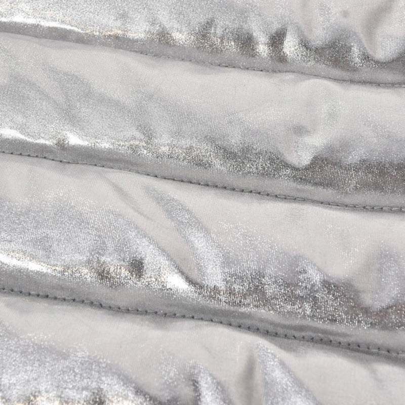 Close-up of shiny metallic silver fabric with quilted texture, highlighting softness and warmth.