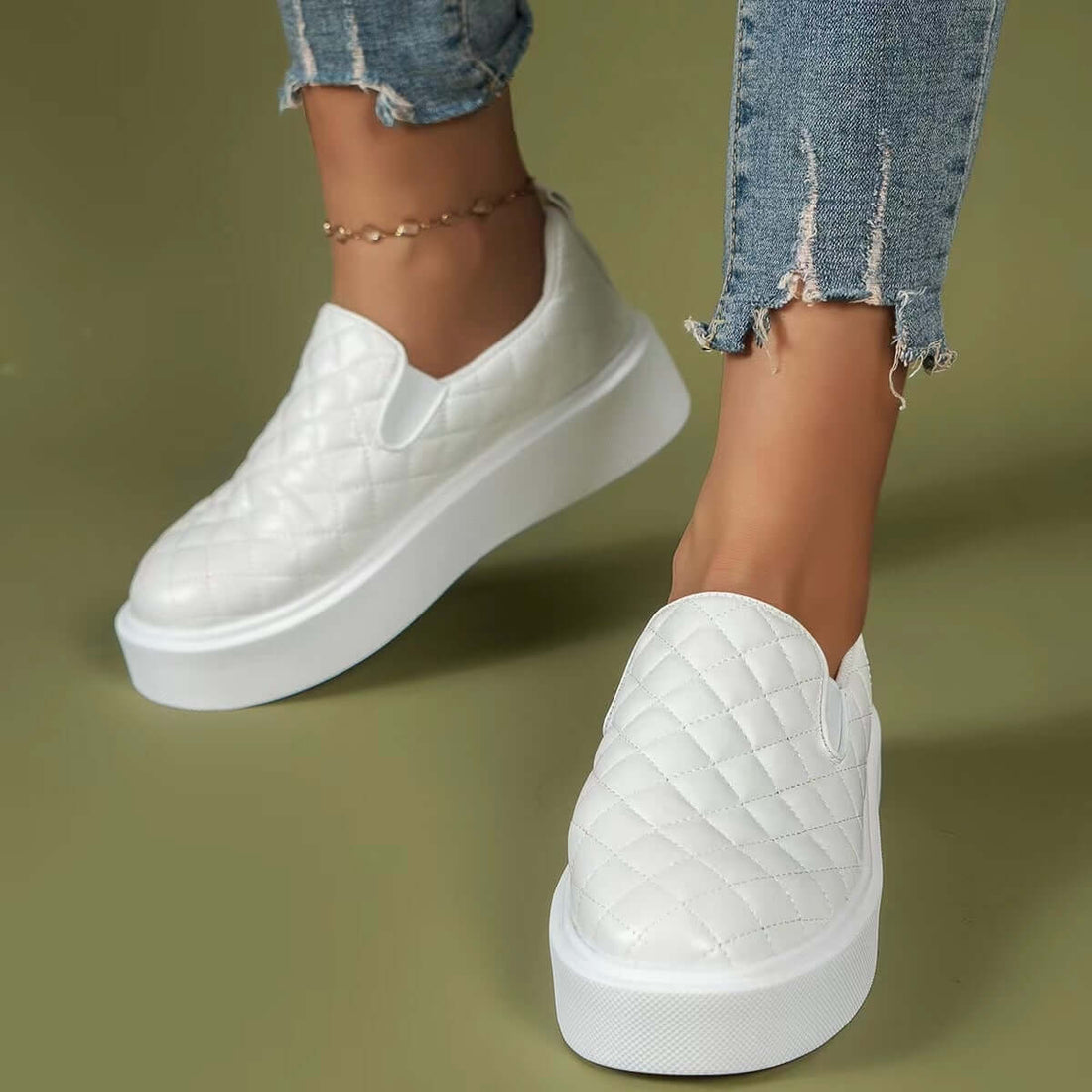 Lightweight white slip-on flats with quilted design and platform sole, perfect for casual everyday wear.