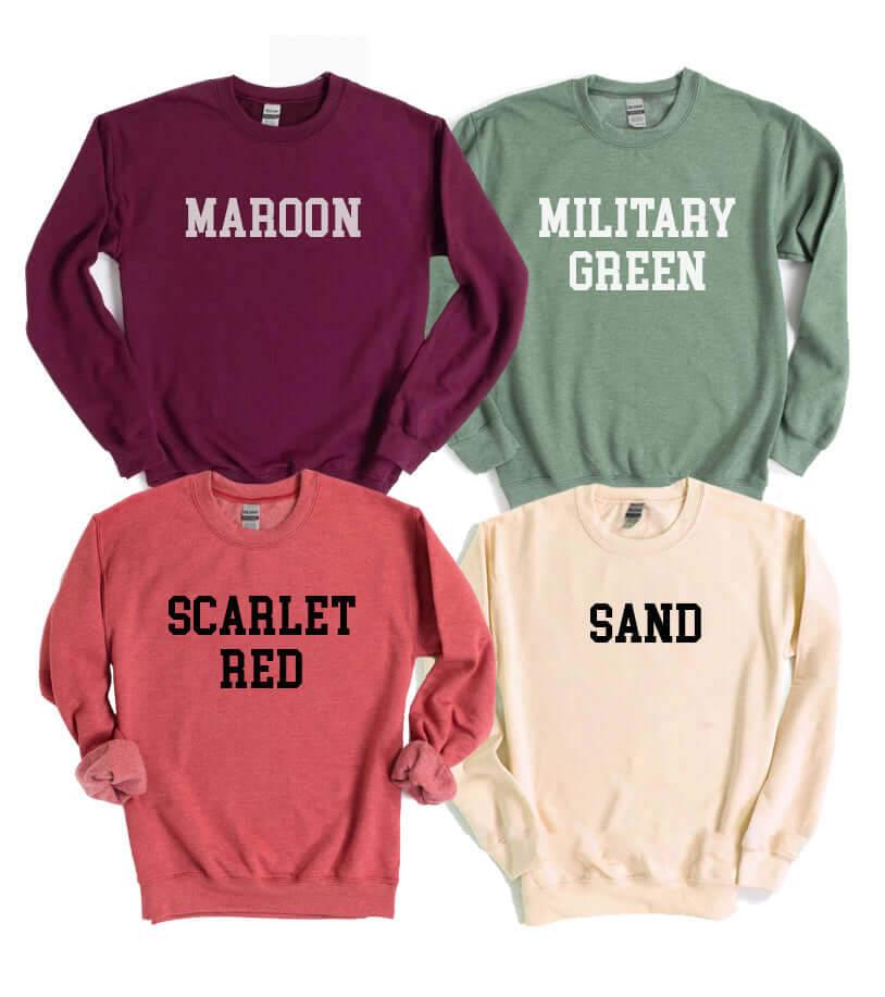 Collection of sweatshirts in maroon, military green, scarlet red, and sand colors, featuring bold text designs.