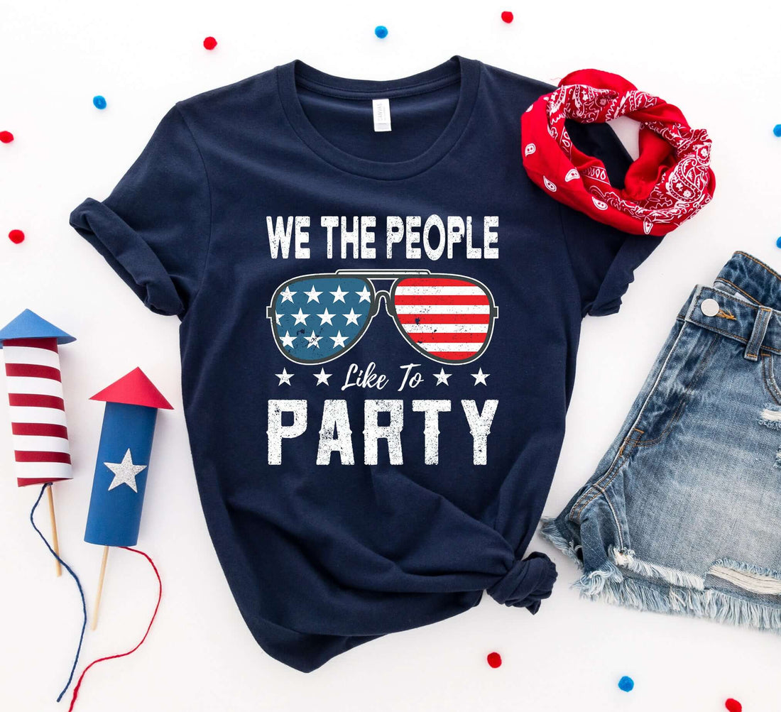 We the People Like to Party T-shirt in navy blue with patriotic glasses design, perfect for 4th of July celebrations.