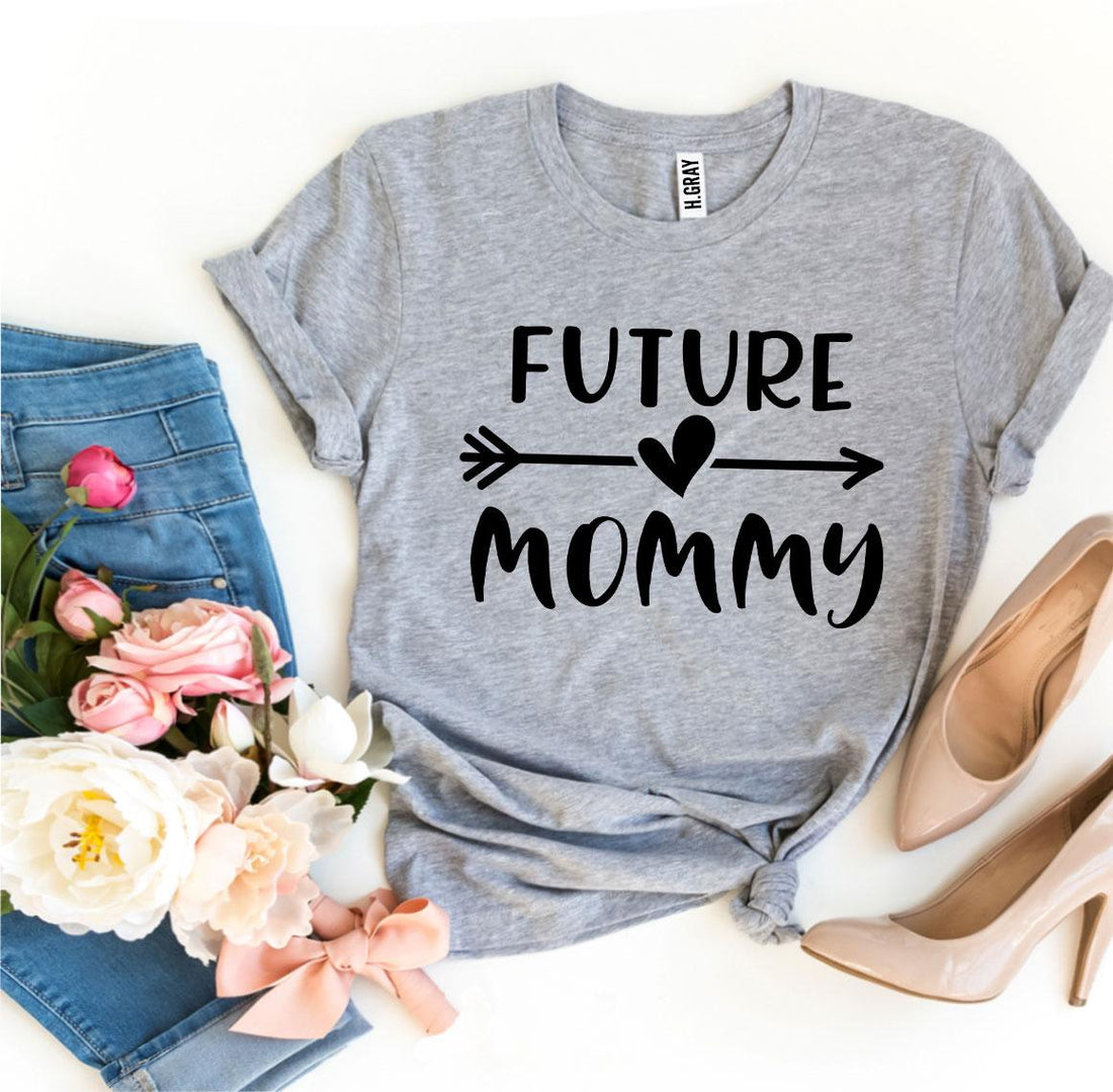 Gray Future Mommy T-shirt with stylish print, paired with jeans, flowers, and chic shoes for a trendy look.