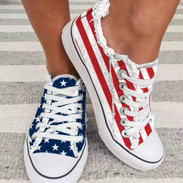 Star striped lace-up sneakers featuring red and white stripes and blue star pattern, perfect for casual wear.