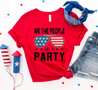 We the People Like to Party red t-shirt with patriotic sunglasses design for 4th of July celebrations.