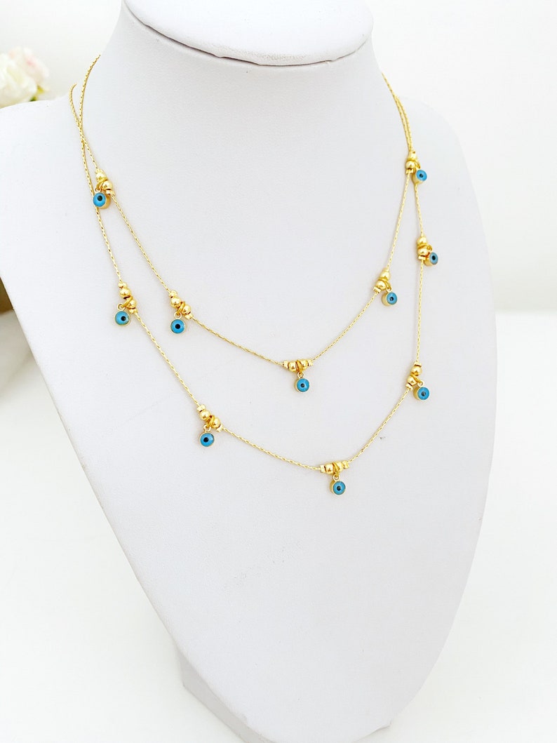 Dainty blue evil eye necklace on gold chain, view 3