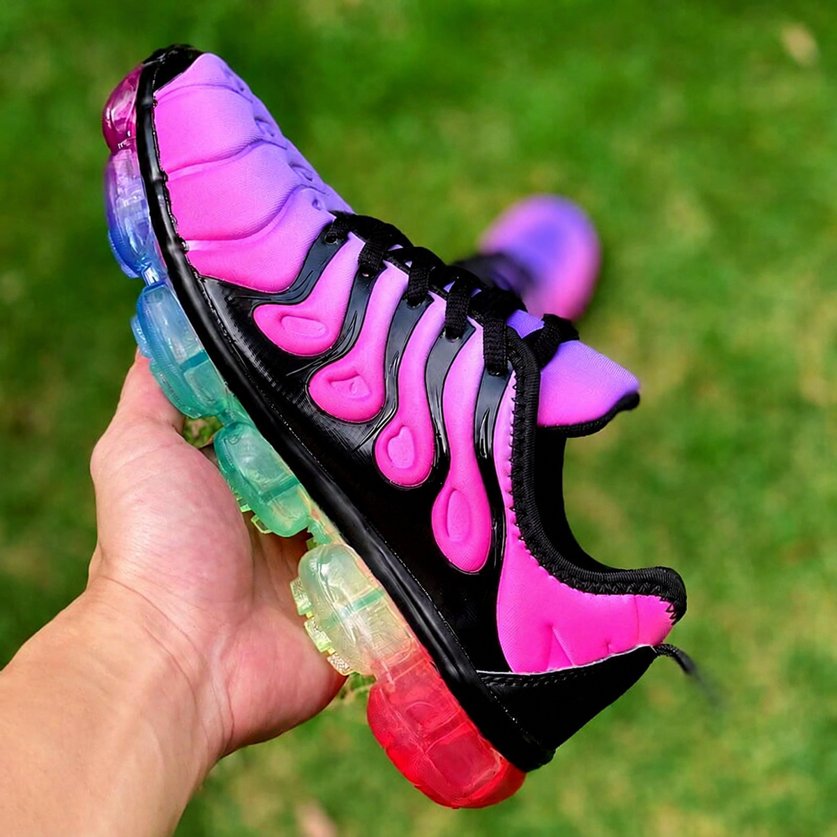 Vibrant pink and black running sneakers with colorful soles, perfect for summer workouts and stylish training sessions.